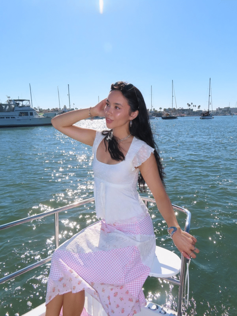 Brianna Gomez embraces sunshine and serenity, embodying mindset rules with grace on a dreamy marina day.