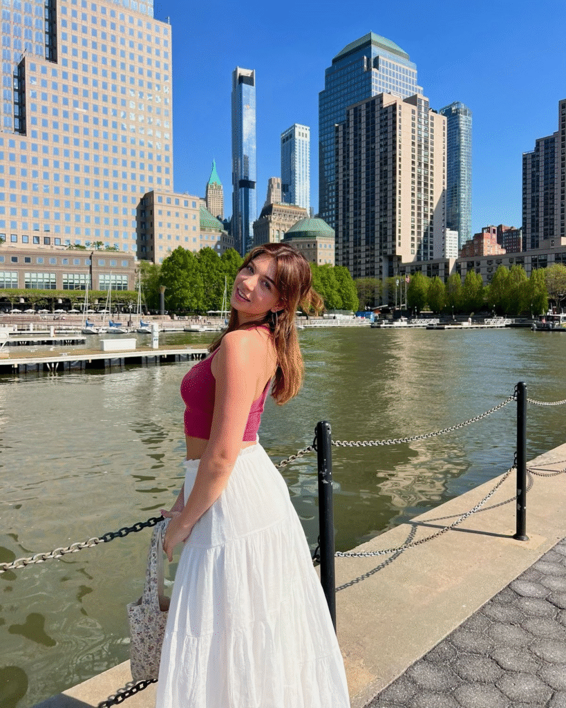 Zhirelle Cushman stands poised against a sunlit cityscape—radiant, serene, and unmistakably rich in feminine energy.